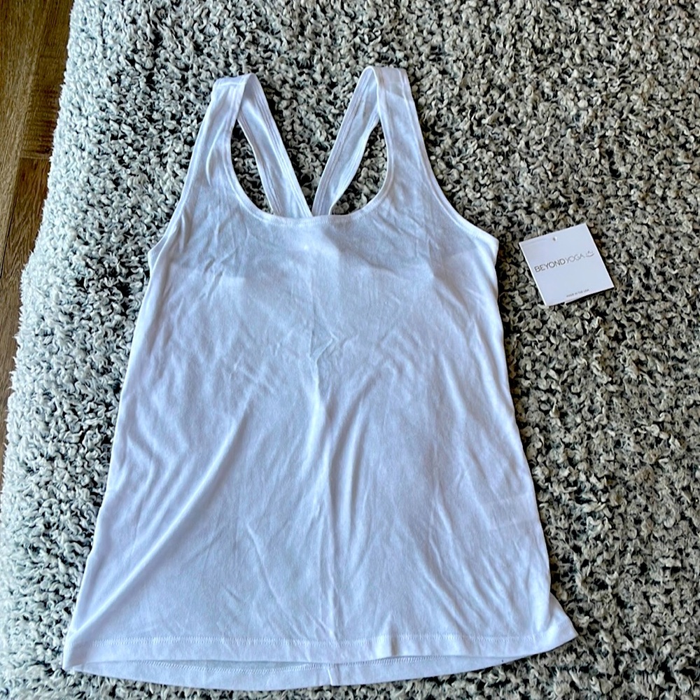 Beyond yoga white tank. Size says xs but runs pretty large like a S or even M.